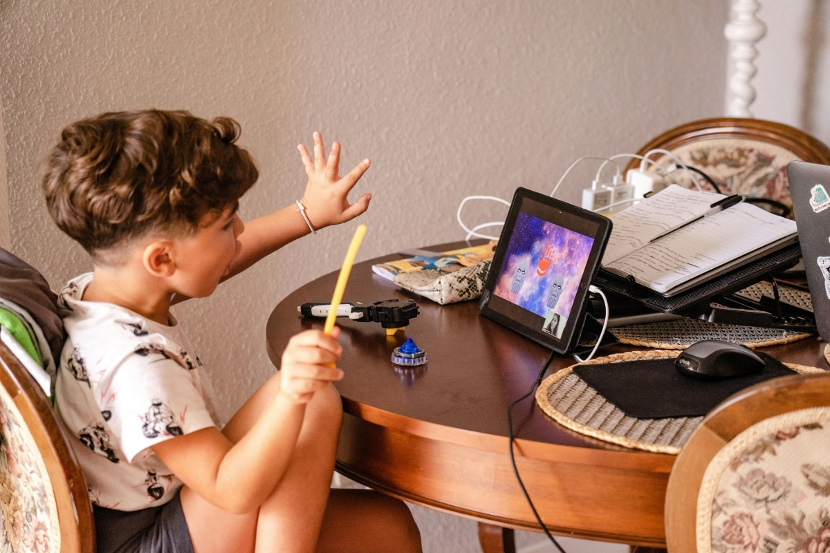Preschool child watching tablet screen for long duration indoors